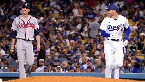 Los Angeles Dodgers' Freddie Freeman, right, smiles at Atlanta Braves starting pitcher Max Fried after being thrown out at first during the fourth inning of a baseball game Tuesday, April 19, 2022, in Los Angeles. (AP Photo/Mark J. Terrill)