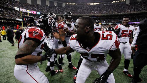 Prince Shembo (53) celebrates with Robert McClain of the Falcons following an interception against the New Orleans Saints during a game at the Mercedes-Benz Superdome on Dec. 21, 2014 in New Orleans. (Photo by Sean Gardner/Getty Images)