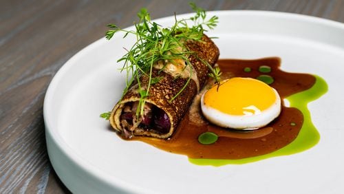 At Aix, a duck egg is served alongside the duck confit crepe.