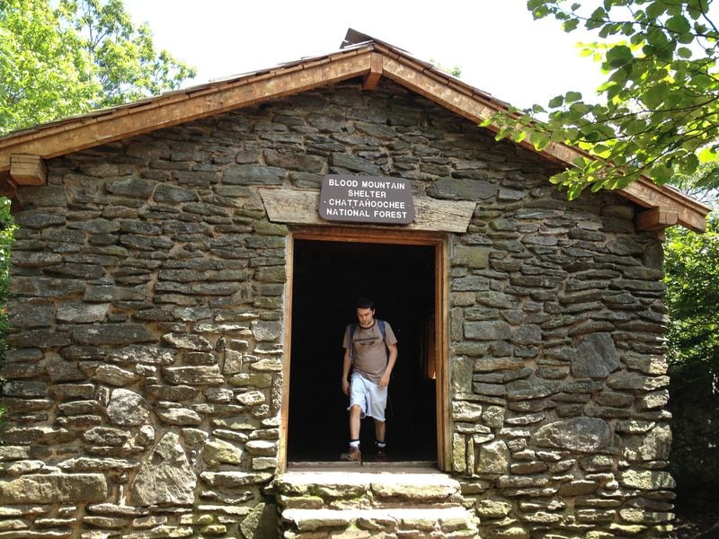 Hiker Andrew Norris exists the Blood Mountain shelter. PHOTO CREDIT: Phil W. Hudson