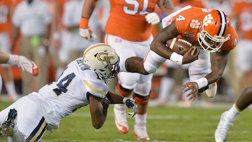 Clemson quarterback Deshaun Watson (4) gets tackled by Georgia Tech strong safety Corey Griffin (14) in the first half at Bobby Dodd Stadium on Thursday, September 22, 2016. HYOSUB SHIN / HSHIN@AJC.COM