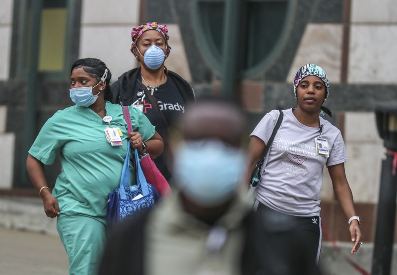 Grady Memorial Hospital medical workers leave after their shifts in downtown Atlanta on Wednesday, April 8, 2020. JOHN SPINK/JSPINK@AJC.COM