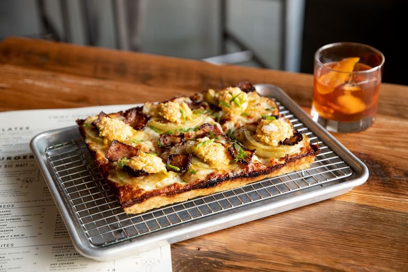 Emmy Squared's the Shed pizza, with green tomato, "zia" cheese, bacon jam, and green onions, with an Out of Fashion cocktail. Mia Yakel for The AJC