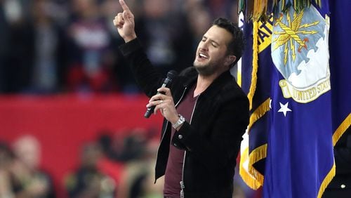 HOUSTON, TX - FEBRUARY 05: Luke Bryan sings the National Anthem prior to Super Bowl 51 between the New England Patriots and the Atlanta Falcons at NRG Stadium on February 5, 2017 in Houston, Texas. (Photo by Elsa/Getty Images)
