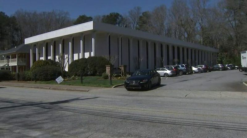 A woman was robbed at gunpoint and forced back into her own car outside this building in the 200 block of West Wieuca Road in Buckhead, police said. (Credit: Channel 2 Action News)