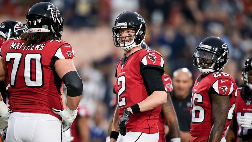 Atlanta Falcons quarterback Matt Ryan, center, warms up with tackle Jake Matthews, left, and running back Tevin Coleman before an NFL football wild-card playoff game against the Los Angeles Rams Saturday, Jan. 6, 2018, in Los Angeles. (AP Photo/Kelvin Kuo)
