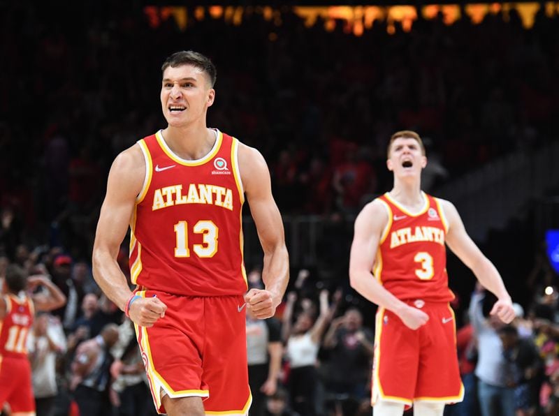 Hawks Bogdan Bogdanovic (13) andKevin Huerter (3) react at the end of the 4th quarter in Game 3 of the first round of the NBA playoffs at State Farm Arena on Friday, April 22, 2022. (Hyosub Shin / Hyosub.Shin@ajc.com)