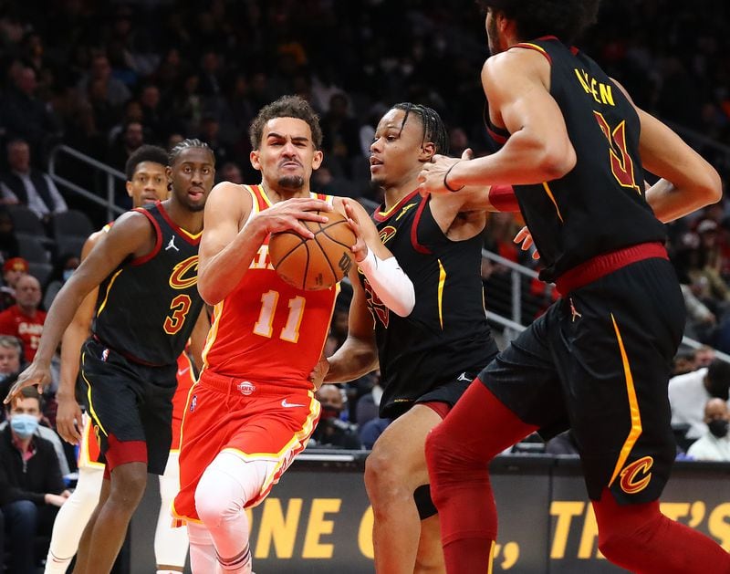 Hawks guard Trae Young drives to the basket through three Cavaliers defenders for two of his 41 points Tuesday in Atlanta. (Curtis Compton / Curtis.Compton@ajc.com)`