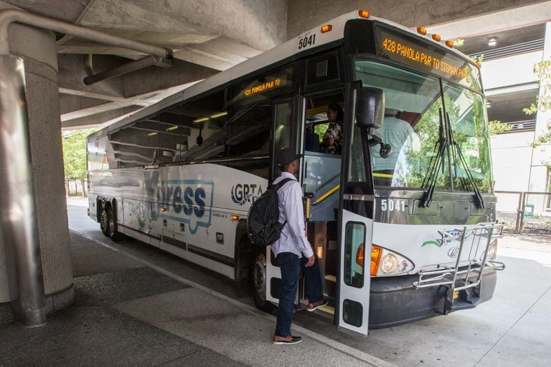 Passengers board a GRTA Xpress bus at the Dunwoody Marta Station, Monday, Aug. 10, 2015, in Dunwoody, Ga. BRANDEN CAMP/SPECIAL