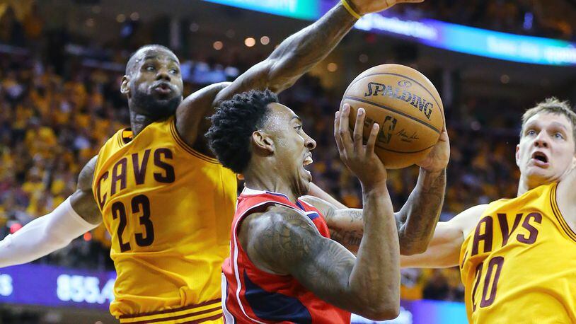 Hawks’ Jeff Teague looks to pass off under the basket drawing a double team from Cavaliers’ LeBron James and Timofey Mozgov in Game 4 of the Eastern Conference Finals on Tuesday, May 26, 2015, in Cleveland. Curtis Compton / ccompton@ajc.com