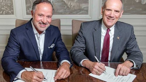 Greg Parker, president, founder and CEO of The Parker Companies in Savannah, and Allen C. Amason, dean of the Parker College of Business, sign an agreement detailing plans for the Gregory M. Parker College of Business at Georgia Southern University. PHOTO CONTRIBUTED.