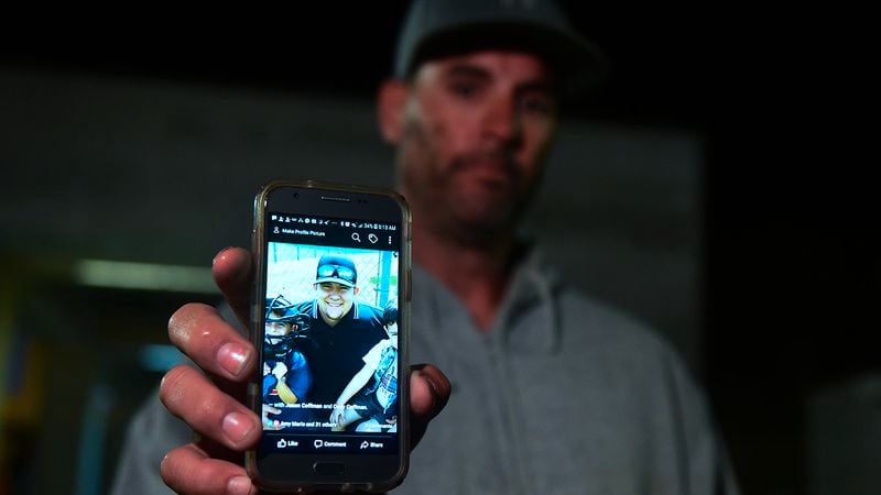 Jason Coffman displays a photo of his son Cody outside the Thousands Oaks Teene Center where he came hoping to find his son who was at the Borderline Bar and Grill in Thousand Oaks, California, on November 8, 2018. - Twelve people, including a police sergeant, were shot dead in a shooting at the bar close to Los Angeles, police said Thursday. All the victims were killed inside the bar in the suburb of Thousand Oaks late on November 7, including the officer who had been called to the scene, Sheriff Geoff Dean told reporters. The gunman was also dead at the scene, Dean added.