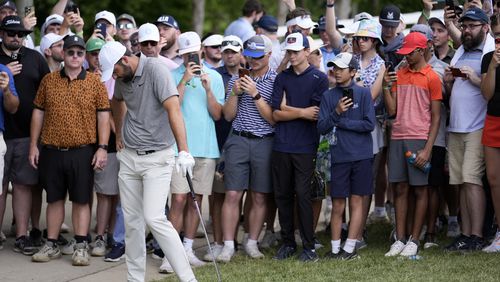Scottie Scheffler reacts to his chip to the green on the fourth hole during the third round of the PGA Championship golf tournament at the Valhalla Golf Club, Saturday, May 18, 2024, in Louisville, Ky. (AP Photo/Jeff Roberson)