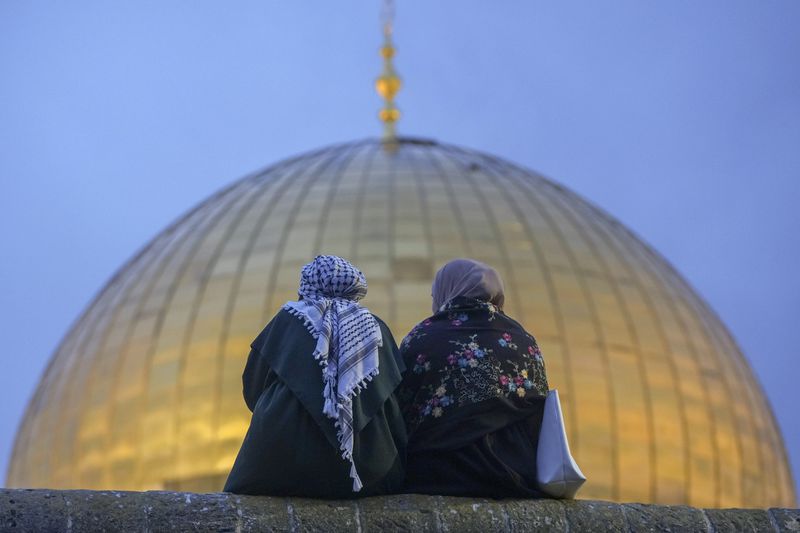 Palestinians gather for Eid al-Fitr prayers by the Dome of the Rock shrine in the Al Aqsa Mosque compound in Jerusalem's Old City, Wednesday, April 10, 2024. The holiday marks the end of the holy month of Ramadan, when devout Muslims fast from sunrise to sunset. (AP Photo/Mahmoud Illean)