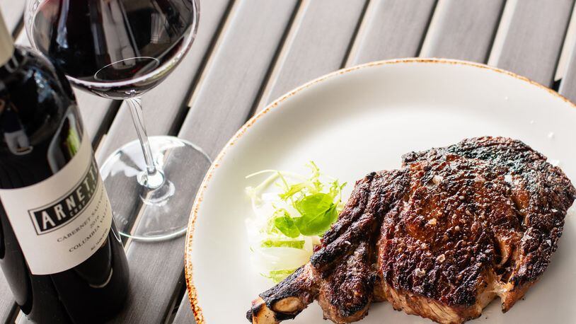 Although Arnette’s Chop Shop in Brookhaven is closed for dine-in service, customers still can enjoy its steakhouse fare, like a 22-ounce cowboy rib-eye (pictured), paired with the house label red wine. CONTRIBUTED BY HENRI HOLLIS
