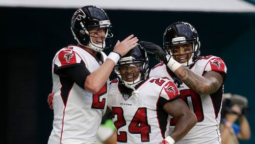 Atlanta Falcons quarterback Matt Ryan (2) and tight end Levine Toilolo (80) congratulate running back Devonta Freeman (24), after Freeman scored at touchdown during the first half against the Miami Dolphins, Thursday, Aug. 10, 2017 in Miami Gardens, Fla.
