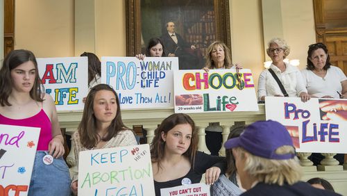 03/22/2019 -- Atlanta, Georgia -- Pro-Choice and Pro-Life demonstrators display their signs during the 35th legislative day at the Georgia State Capitol building in downtown Atlanta, Friday, March 22, 2019. The Georgia Senate is set for a lengthy debate on the anti-abortion "heartbeat bill" Friday. Sen. Renee Unterman is carrying the bill for Rep. Ed Setzler.  (ALYSSA POINTER/ALYSSA.POINTER@AJC.COM)