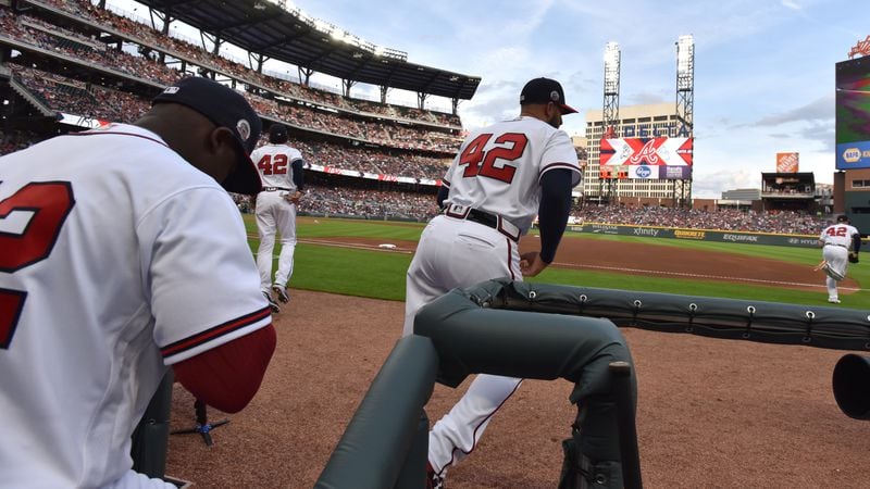 Atlanta Braves players,  wearing No. 42 in honor of Jackie Robinson, take the field at SunTrust Park against the San Diego Padres on Jackie Robinson Day Saturday, April 15, 2017, in Atlanta.