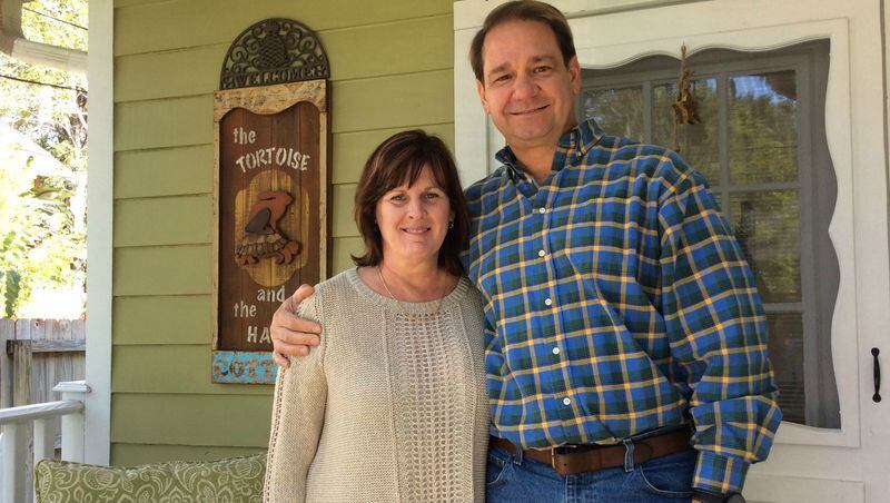 Teri Ern, left, and her husband, Rob Ern, stand on the porch of The Tortoise and The Hare Cottage, one of two short-term vacation rentals they own in Mount Dora. Unlike some hosts of home-sharing venues on Airbnb and VRBO, they are state-licensed and collect lodging taxes. (Stephen Hudak/Orlando Sentinel/TNS)