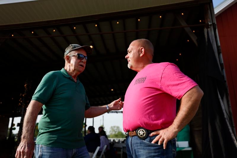 Washington County Sherrif Joel Cochran (right) speaks with resident Les Brantley moments before a re-election campaign event in Tennille, GA, on Tuesday, April 16, 2024. “It really is a 50-50 county, politically,” Cochran said. (Miguel Martinez / AJC)
 