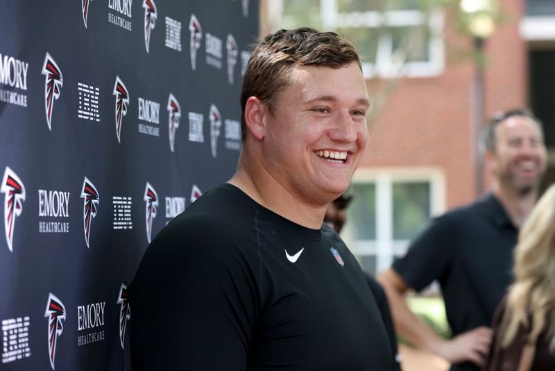 Falcons guard Chris Lindstrom speaks to the media as he arrives for training camp Tuesday in Flowery Branch. (Jason Getz / Jason.Getz@ajc.com)