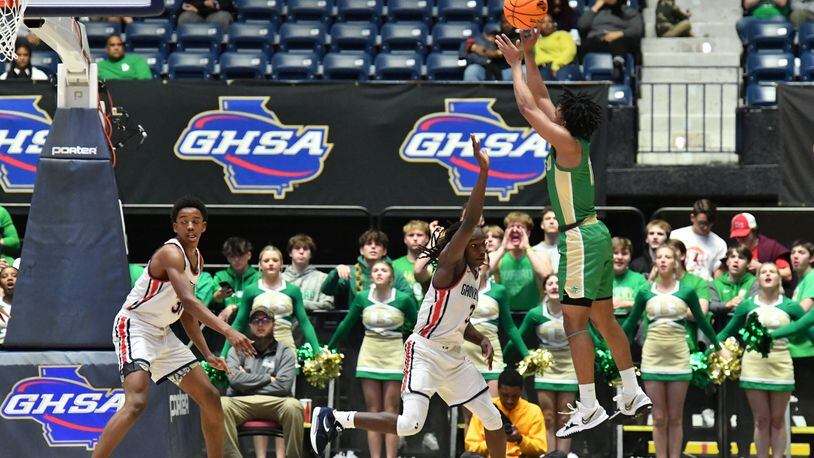 March 11, 2022 Macon - Buford's Malachi Brown (right) shoots for two points over Grovetown's Khaleed Heywood (3) during the 2022 GHSA State Basketball Class AAAAAA Boys Championship game at the Macon Centreplex in Macon on Friday, March 11, 2022. Grovetown won 66-59 over Buford.  (Hyosub Shin / Hyosub.Shin@ajc.com)