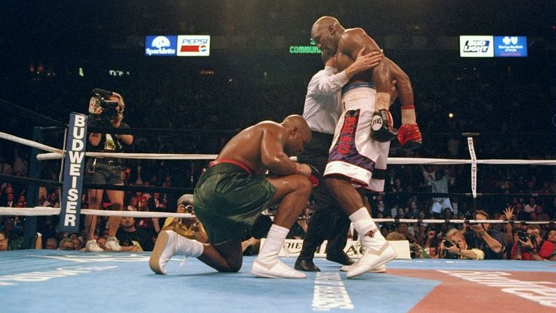 Evander Holyfield knocks down Michael Moorer during a fight at the Thomas and Mack Center in Las Vegas,.  Holyfield won the fight by a technical knockout.