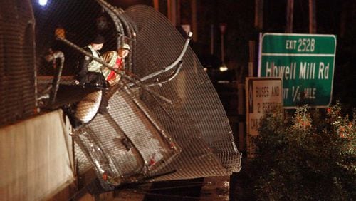 A charter bus carrying the Bluffton University baseball team crashed through the fence on the Northside Drive bridge over Interstate 75 on March 2, 2007. AJC file photo