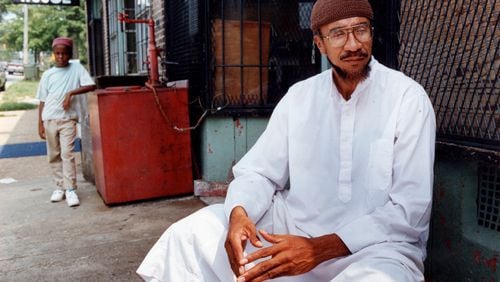 Imam Jamil Abdullah Al-Amin, the former H. Rap Brown, in front of his West End Community grocery store on Oak Street in 1990. (Kathryn Kolb/AJC file photo)