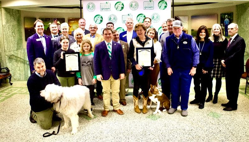 Georgia Agriculture Commissioner Tyler Harper (center, striped tie) recognized Casper, left, and Skippy (right) for their recent awards from the American Farm Bureau.