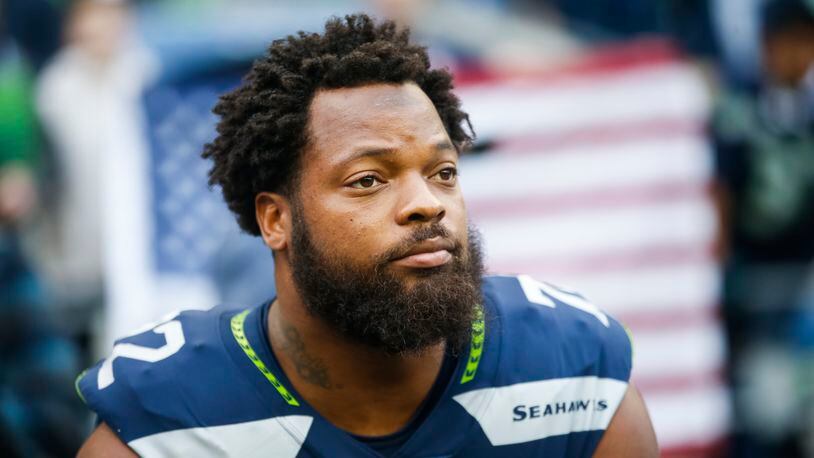 SEATTLE, WA - OCTOBER 1: Defensive end Michael Bennett #72 of the Seattle Seahawks sits on the bench during the national anthem before the game against the Indianapolis Colts at CenturyLink Field on October 1, 2017 in Seattle, Washington. (Photo by Otto Greule Jr /Getty Images)