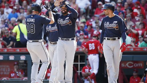 CINCINNATI, OH - JUNE 03: Matt Adams #18 of the Atlanta Braves is congratulated by Matt Kemp #27 and Nick Markakis #22 after hitting a grand slam in the fifth inning of a game against the Cincinnati Reds at Great American Ball Park on June 3, 2017 in Cincinnati, Ohio. The Braves defeated the Reds 6-5 in 12 innings. (Photo by Joe Robbins/Getty Images)