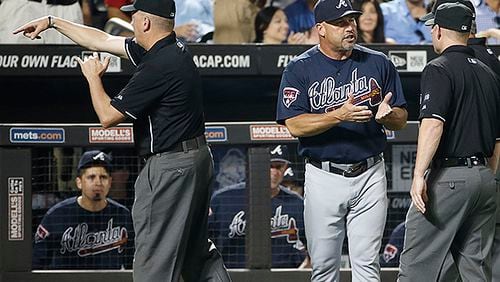 Third base umpire Mike Everitt, the crew chief, tosses Atlanta Braves manager Fredi Gonzalez from the game as Gonzalez argues the call on a second base play in Monday's loss to the Mets. (AP Photo/Kathy Willens)