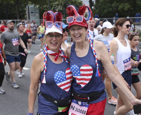 Shelly Folino (left) and Sherry Gallagher, from Kennesaw, at the 53rd running of the Atlanta Journal-Constitution Peachtree Road Race in Atlanta on Monday, July 4, 2022. (Jason Getz / Jason.Getz@ajc.com)