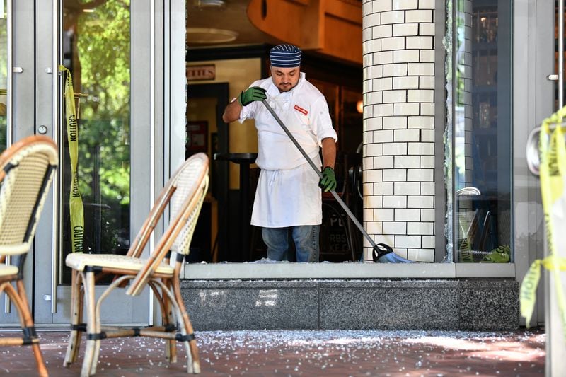 May 30, 2020 Atlanta - An employee cleans up after a night of riots and looting in Buckhead area at Bistro Niko restaurant on Peachtree Road in Buckhead on Saturday, May 30, 2020. Atlanta woke up Saturday to shattered glass and the burned hulks of police cars following a protest that turned into violent chaos and looting overnight. Protests against the killing George Floyd started out peacefully in downtown Atlanta but eventually devolved into violence with looting and property damage. Protesters made their way from downtown Atlanta and into Buckhead late Friday, damaging businesses, looting and leaving behind a path of destruction. (Hyosub Shin / Hyosub.Shin@ajc.com)