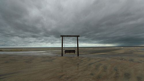 The beach on the northern end of Tybee Island and the sand dunes have suffered signifcant erosion, but a solitary swing remains, as the remnant of Hurricane Matthew passes by on Saturday, Oct. 8, 2016, in Tybee Island. Curtis Compton /ccompton@ajc.com