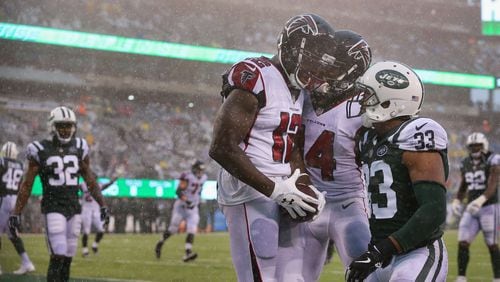 Falcons wide receiver Mohamed Sanu celebrates his celebrates his touchdown with teammate Justin Hardy against New York Jets strong safety Jamal Adams during the fourth quarter Sunday.