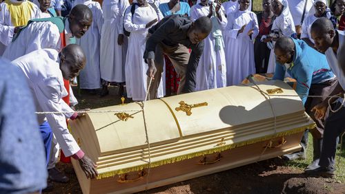 Friends and family lower the casket of Rose Bella Awuor, 31 years, after a funeral service at her home in Awendo, Migori County, Kenya Thursday, April. 11, 2024. Awuor fell ill in December and lost her five-month pregnancy before succumbing to malaria. It was the latest of five deaths in this family attributed to malaria. The disease is endemic to Kenya and is preventable and curable, but poverty makes it deadly for those who can't afford treatment. (AP Photo/Brian Ongoro)