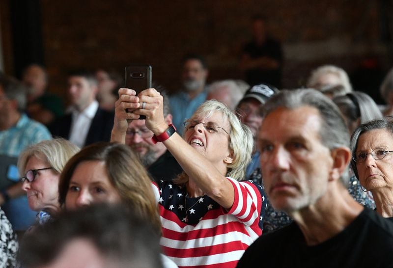 July 13, 2021 Rome - A supporter uses her smartphone to take a picture as U.S. Rep. Marjorie Taylor Greene speaks during a “2020 Election Integrity Townhall” meeting Tuesday in Rome. (Hyosub Shin / Hyosub.Shin@ajc.com)