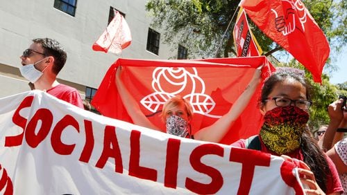 Members of the Democratic Socialists of America hold signs and flags as they march, protesting an alt-right rally on Aug.5, 2018, in downtown Berkeley, California.