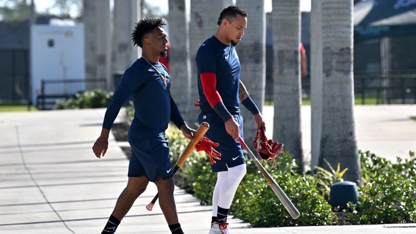 Atlanta Braves second baseman Ozzie Albies (left) and second baseman Orlando Arcia walk back to the clubhouse after taking batting practice during Braves spring training at CoolToday Park, Thursday, Feb. 16, 2023, in North Port, Fla.. (Hyosub Shin / Hyosub.Shin@ajc.com)