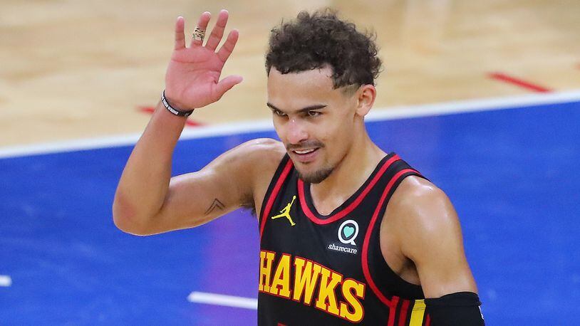Hawks guard Trae Young waves goodbye to booing Philadelphia 76ers fans after winning Game 7 of the Eastern Conference semifinals Sunday, June 20, 2021, in Philadelphia. (Curtis Compton / Curtis.Compton@ajc.com)