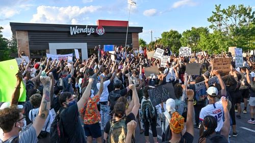 Protesters gather on Saturday, June 13, 2020, at the Atlanta Wendy's where Rayshard Brooks, a 27-year-old black man, was shot and killed by Atlanta police on Friday evening during a struggle in a Wendy's drive-thru line.  Hyosub Shin / hyosub.shin@ajc.com