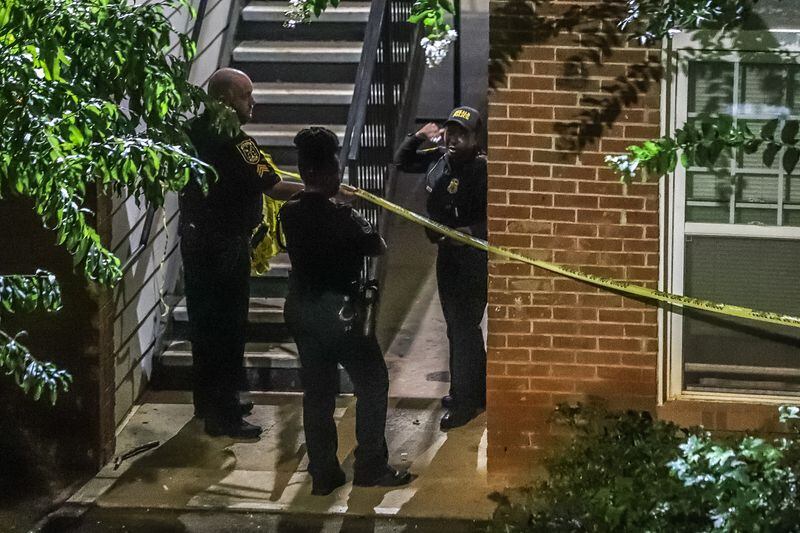 DeKalb County police officers blocked a grassy area outside a breezeway with crime scene tape after a man was found fatally shot Thursday morning.