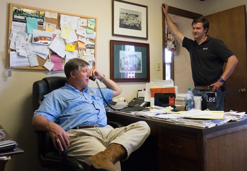 Robert Dickey and his son Lee share an office on their Georgia farm, where their family has been growing peaches for 120 years. (Meera Subramanian / InsideClimate News)