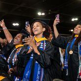 Katharine Ross (center) sings along with “A Choice to Change the World” during Spelman College’s commencement ceremony at the Georgia International Convention Center on Sunday, May 21, 2023.  (Jenni Girtman for The Atlanta Journal-Constitution)