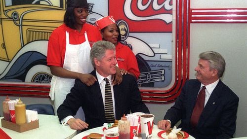 Then-President Clinton enjoyed a grilled chicken sandwich, french fries and a Diet Coke with governor Zell Miller when he visited The Varsity in January 1996. With them are employees Vanessa Dukes (left) and Yolanda Pleasant.