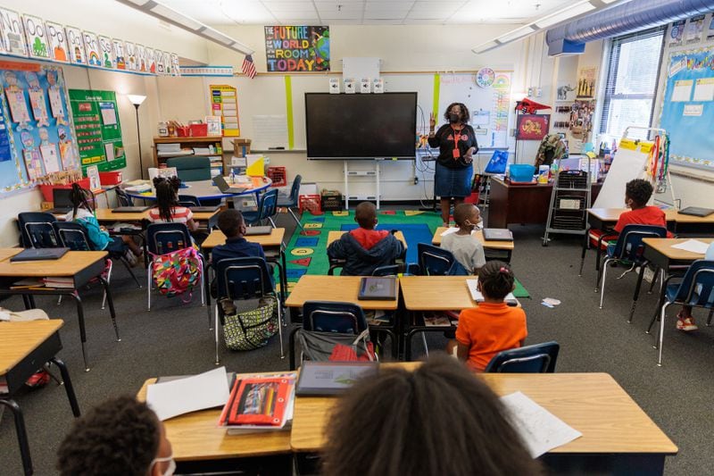 Third grade students listen to teacher Sharie Rosales at T.H. Slater Elementary School. As of the third week of the school year, there were still 157 students with Forest Cove addresses enrolled at the local elementary, middle and high schools. (Arvin Temkar / arvin.temkar@ajc.com)