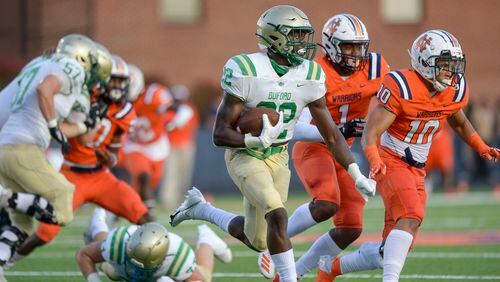 Buford running back Gabe Ervin Jr. (22) gains yardage against the North Cobb defense during Friday's game. (Daniel Varnado/Special to the AJC)