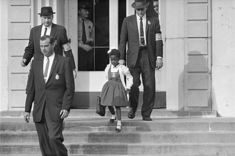 The U.S. Assistant Marshals escorted 6-year-old Ruby Bridges from William Frantz Elementary School in New Orleans in November 1960.  AP FILE Photo